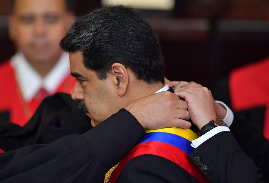 Venezuela's President Nicolas Maduro receives the presidential sash during the inauguration ceremony of his second mandate, at the TSJ headquarters in Caracas on January 10, 2019. - Maduro begins a new term that critics dismiss as illegitimate, with the economy in free fall and the country more isolated than ever. (Photo by Yuri CORTEZ / AFP)