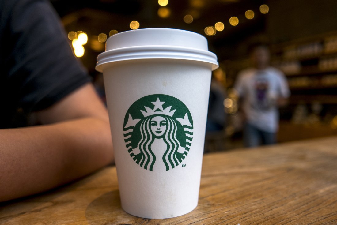 CHENGDU, SICHUAN PROVINCE, CHINA - 2015/09/13: Coffee cup on table in a Starbucks cafe.  Starbucks is streamlining the ordering process so customers are able to get that cup of coffee  faster than usual. (Photo by Zhang Peng/LightRocket via Getty Images)